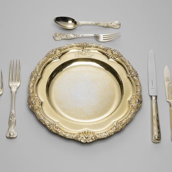 A set of silver-gilt plates; the reeded rim cast with fruiting vines and scallop shells. The plate is engraved with the Royal coat of arms, with supporters, mantling and coronet.