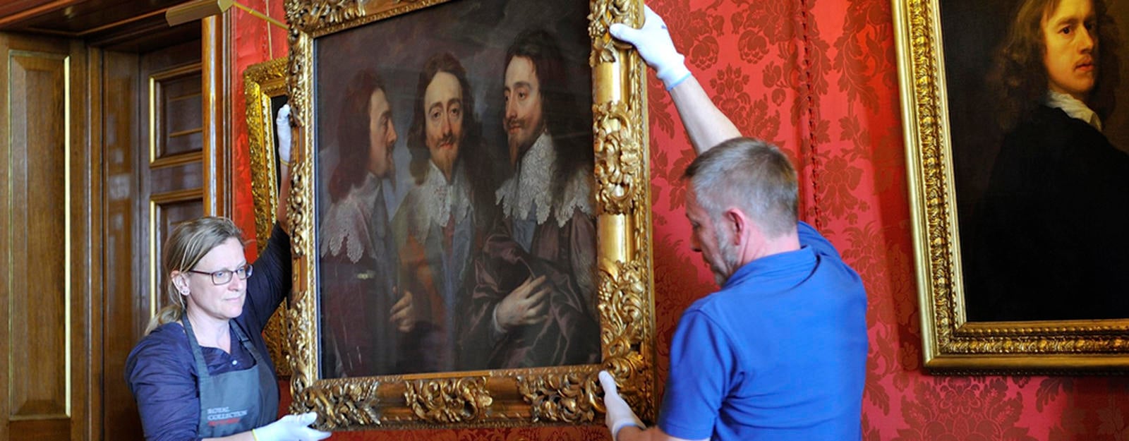 Painting being  moved by art handlers