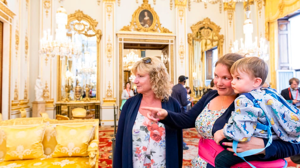Family looking around the White Drawing Room, Buckingham Palace