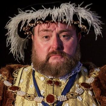 Actor dressed as Henry 8th talks to school pupils