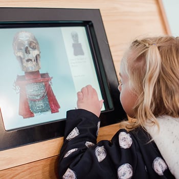 Child with interactive screen at Palace of Holyroodhouse. 