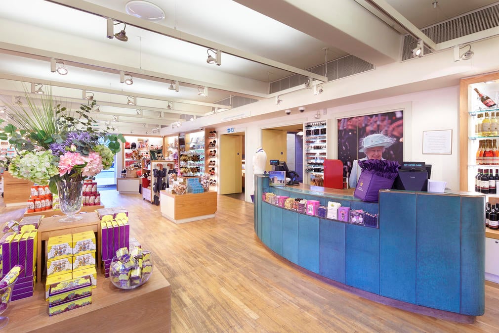 Till, shelves with retail stock and polished wooden floors of the shop