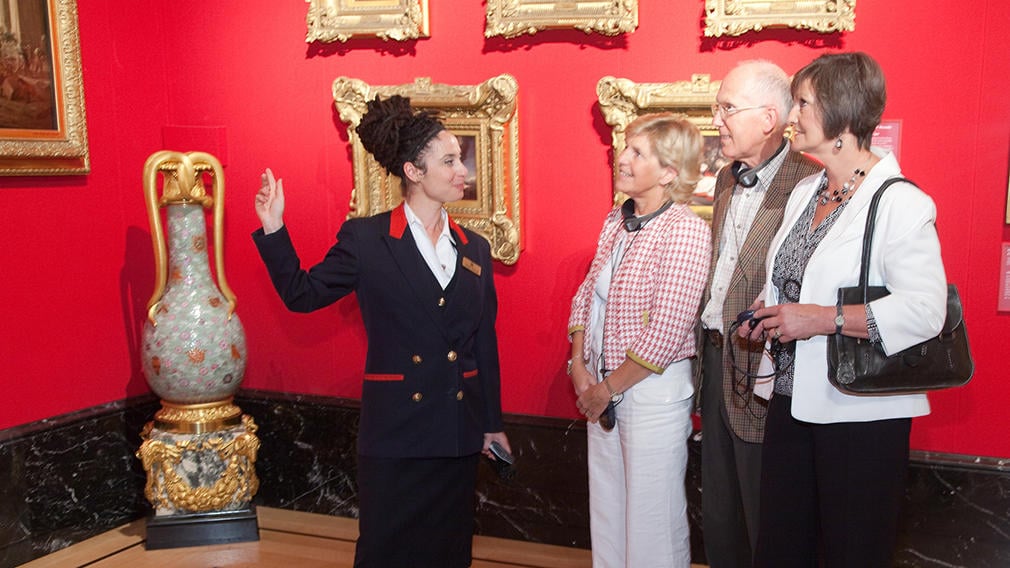 Warden with visitors to The King's Gallery, Buckingham Palace