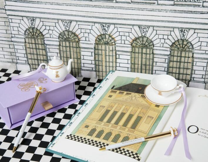 Items from the souvenir range celebrating Queen Mary's Dolls' House, including pens and a miniature tea set.