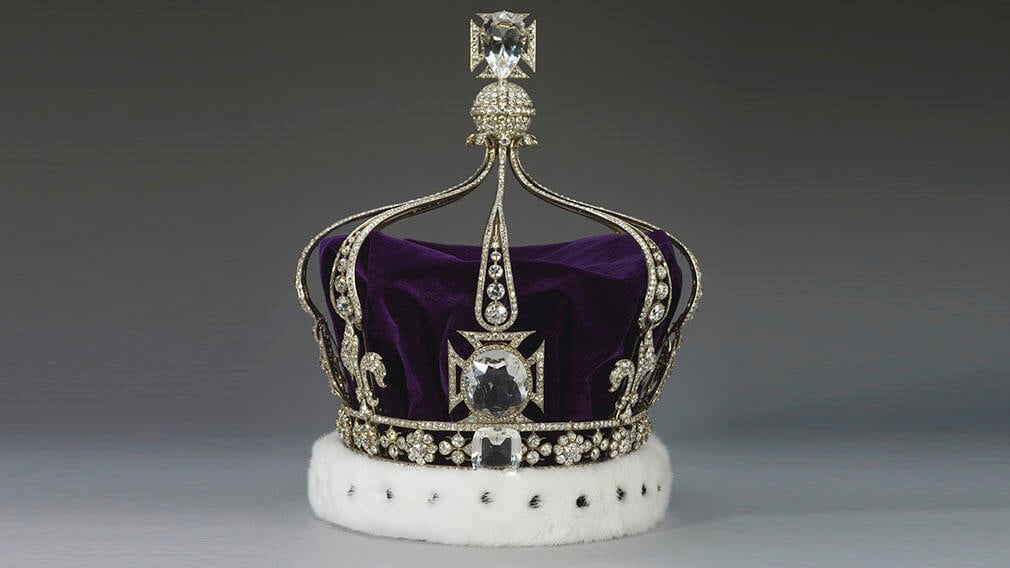 A silver crown with thousands of diamonds and a purple velvet cap.