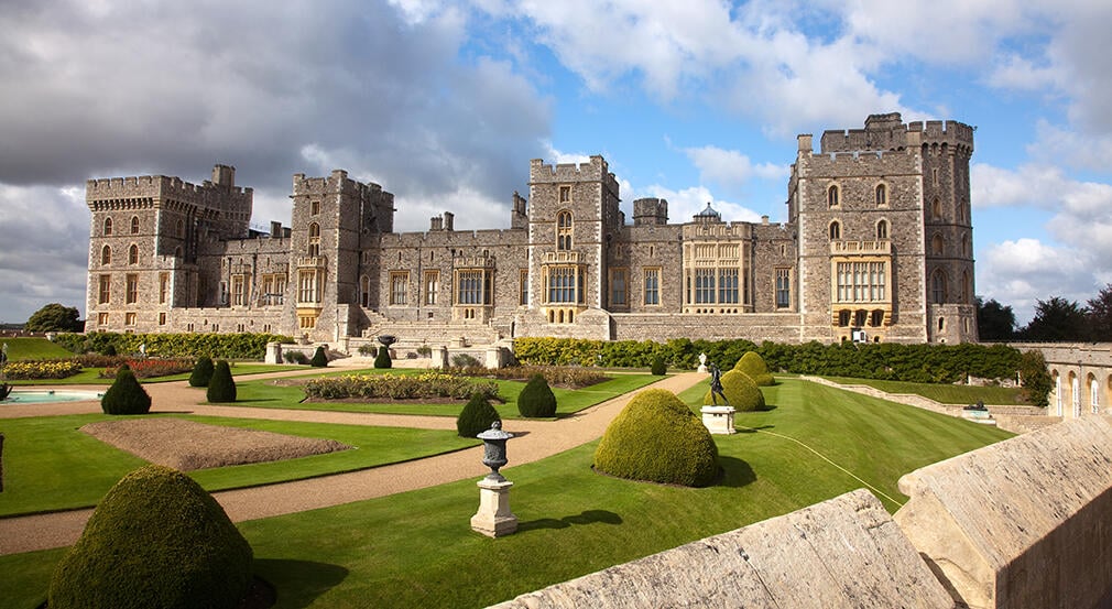 Exterior view of Windsor Castle with gardens in front