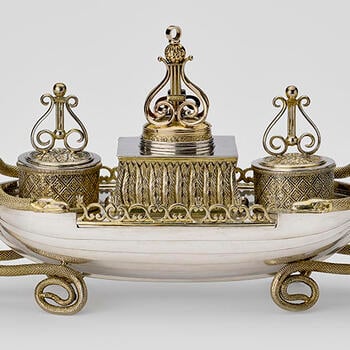 A silver inkstand in the form of a rowing boat 