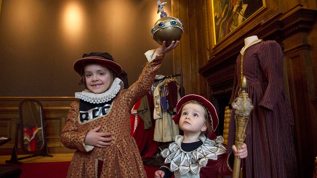 Two children dressed up in historical costumes in the Palace