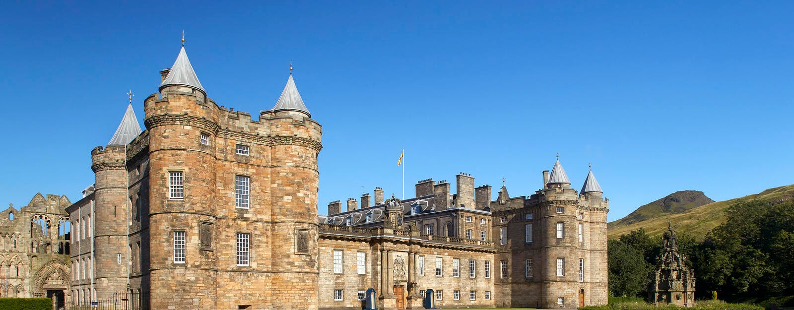 Image of Palace of Holyroodhouse with Holyrood Park  and Arthurs seet in background 