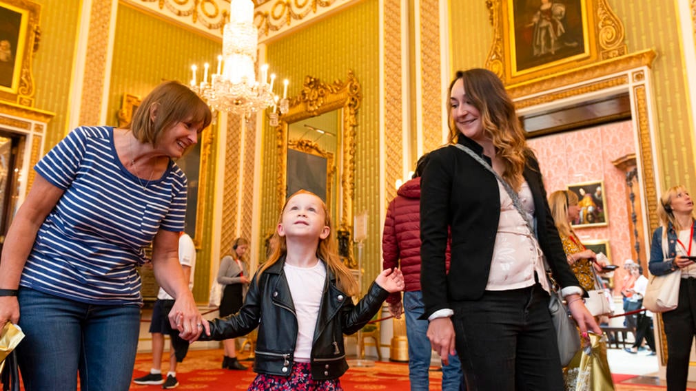 Family walking through the Green Drawing Room, Buckingham Palace