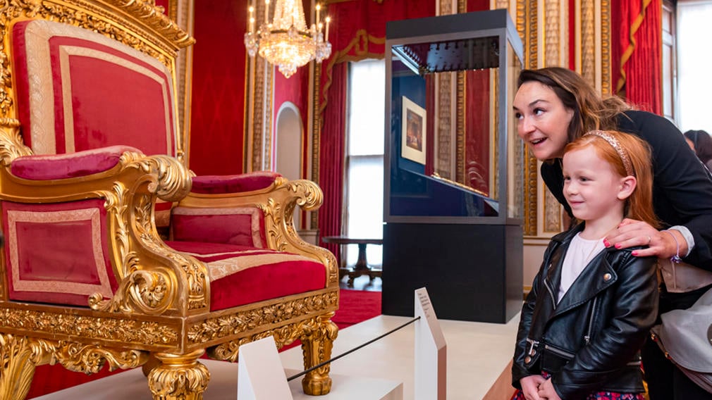 Adult and child look at throne in the Throne Room, Buckingham Palace