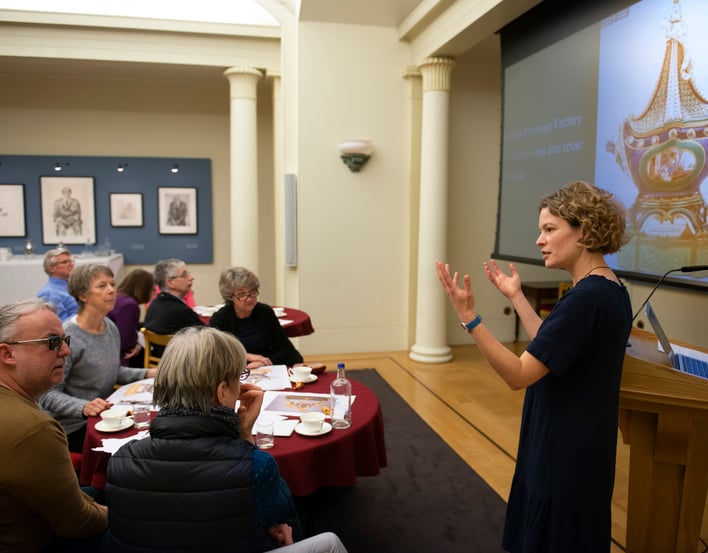 Woman giving a lecture for people at round tables