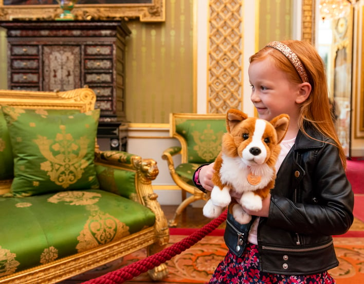 Child with stuffed dog in Royal Palace