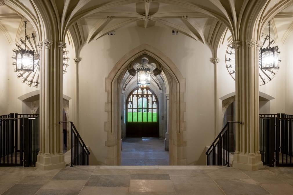 Image shows the Inner Hall of Windsor Catle. A large open space with stone columns.