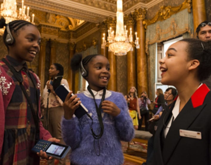 A Warden talking about the multimedia guide during the Summer Opening of Buckingham Palace